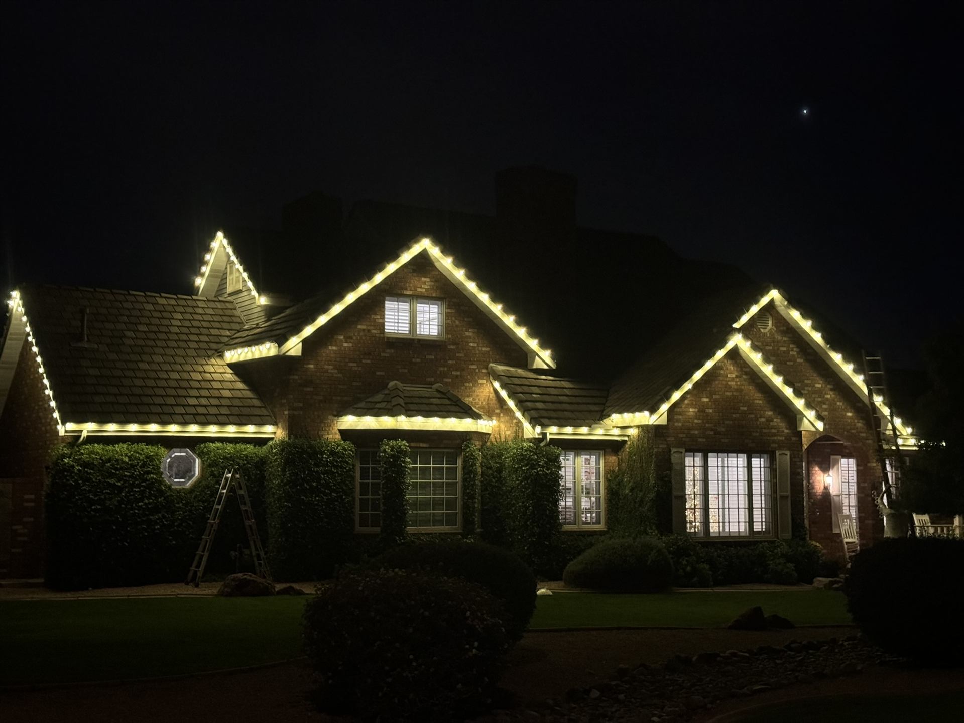 Warm white holiday lighting on single-story house